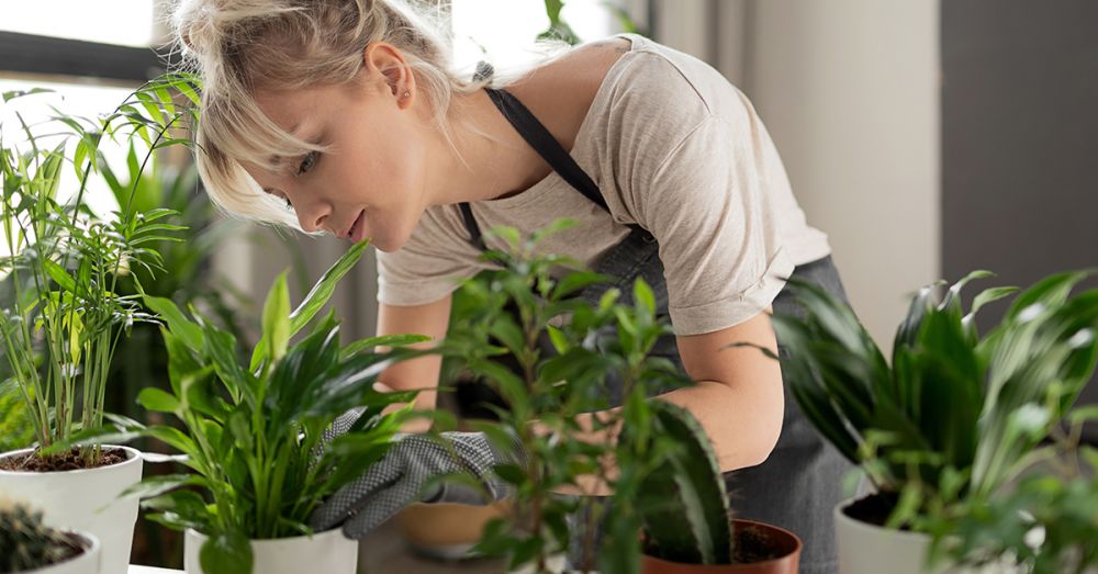 woman tending to plants in dungarees