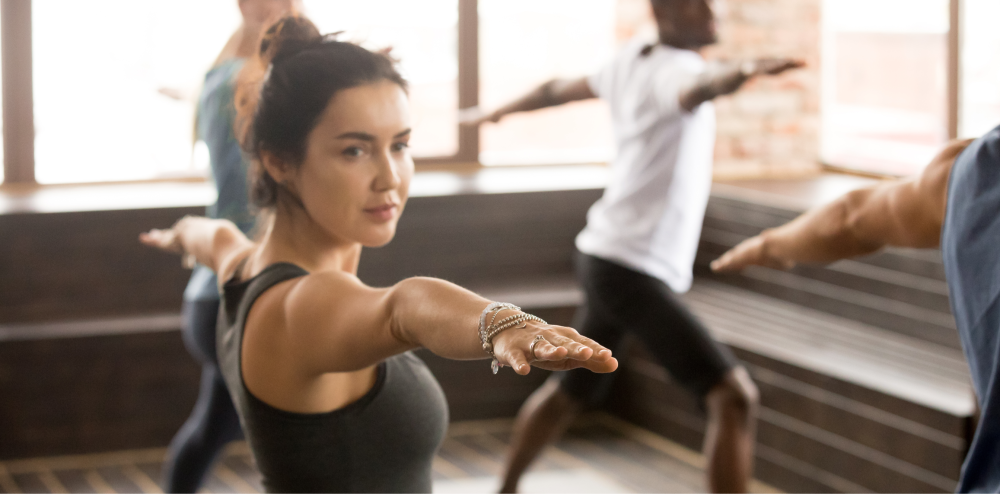 woman doing yoga in a group