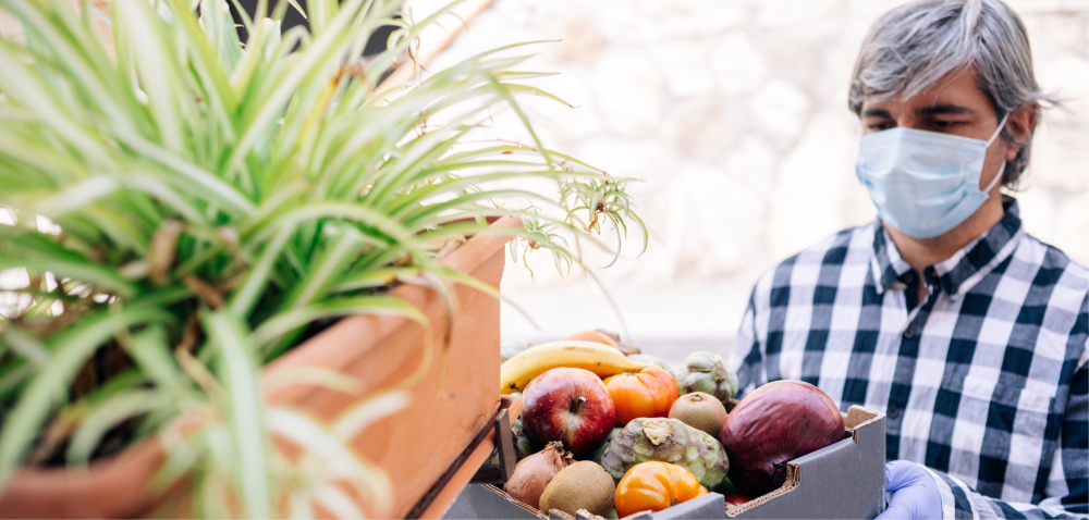 a voluntreer with a veg box