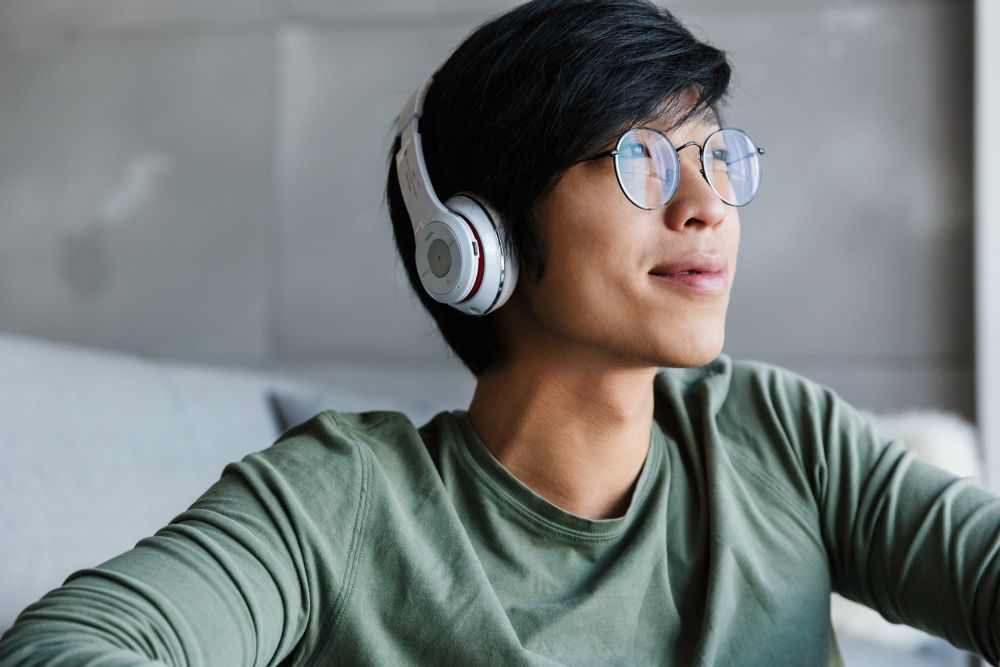 a young man wearing wireless headphones