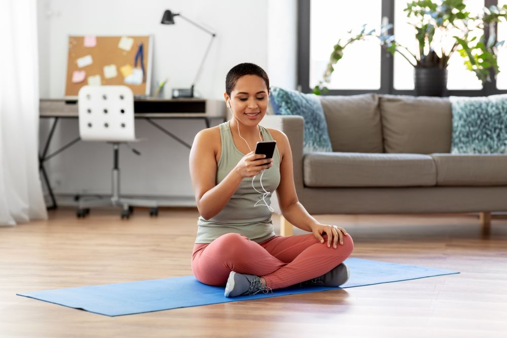 a woman doing an online yoga class at home