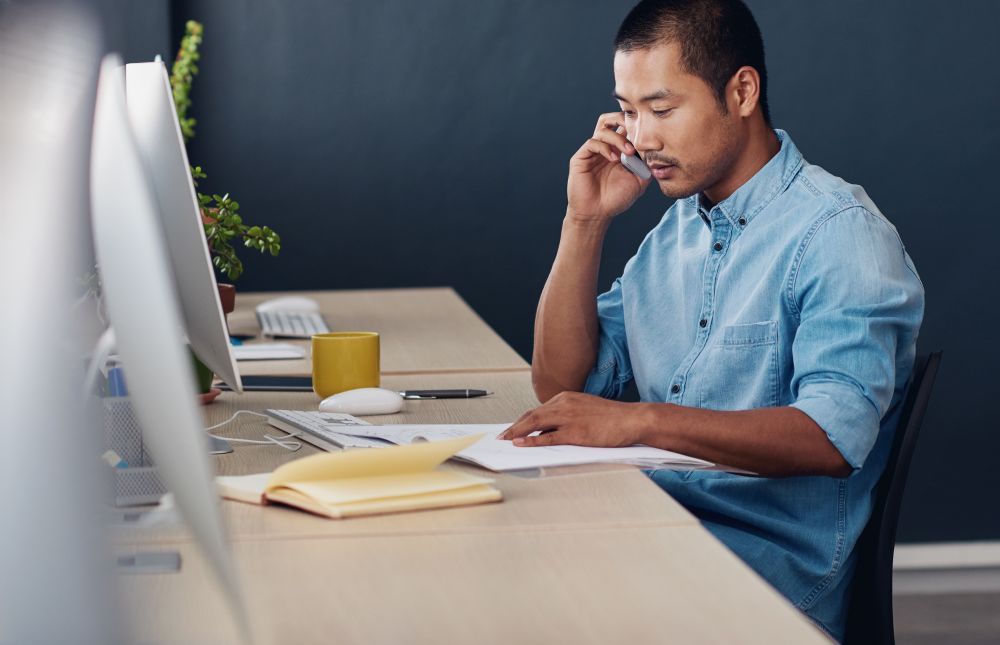 a young man working at his desk