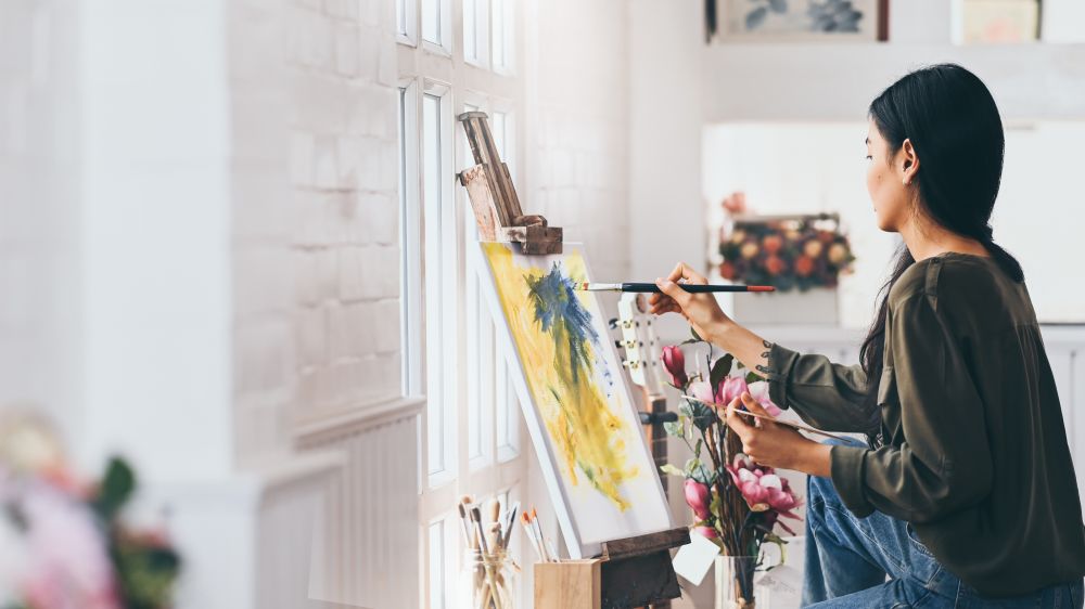 Woman Artist Works on Abstract acrylic painting in the art studio