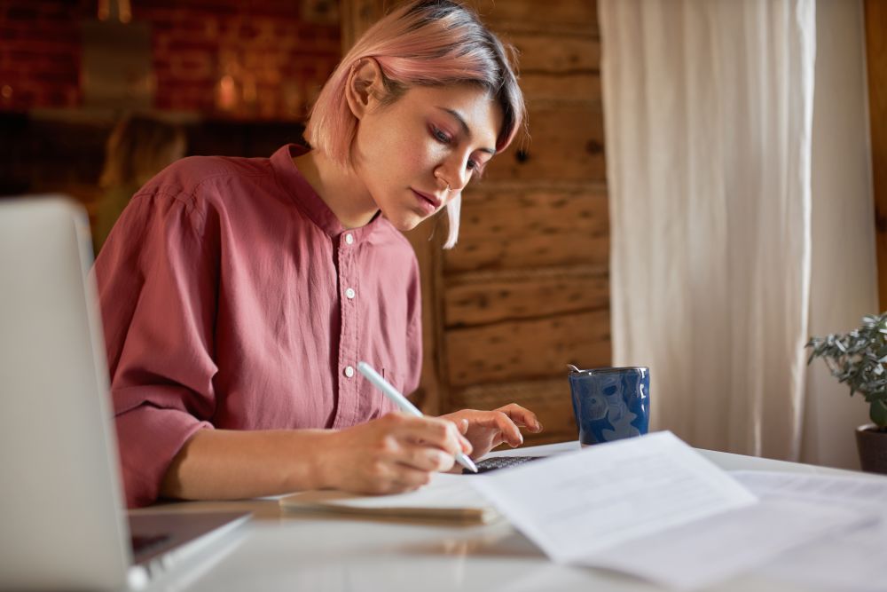 Focused female business owner using laptop for work