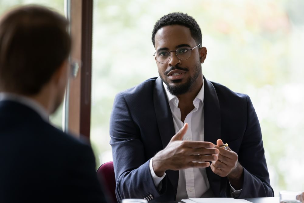 Focused businessman speak with coworker