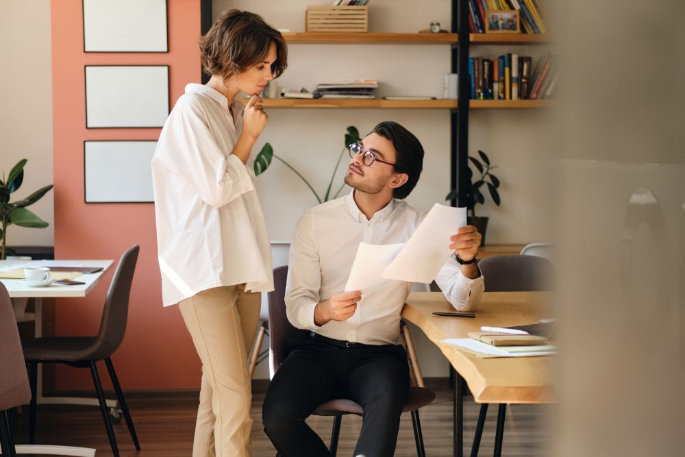 Coworkers talking to each other at office space