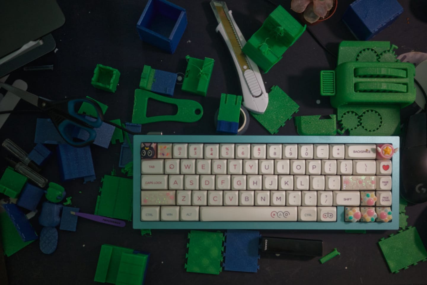 a photo of celina's current keyboard with 3d printed materials surrounging it