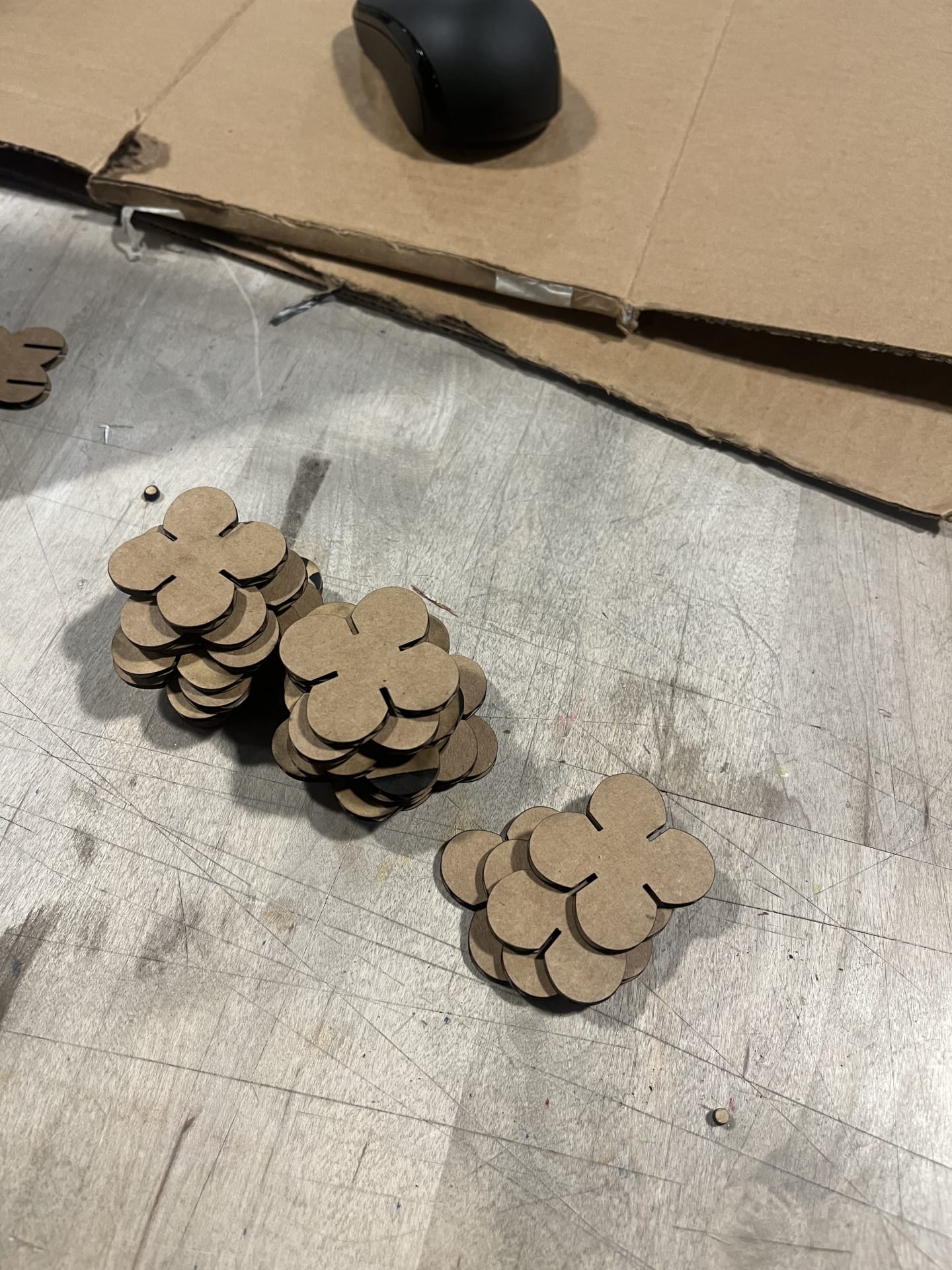 Pile of lasercut butterfly shapes on a table.
