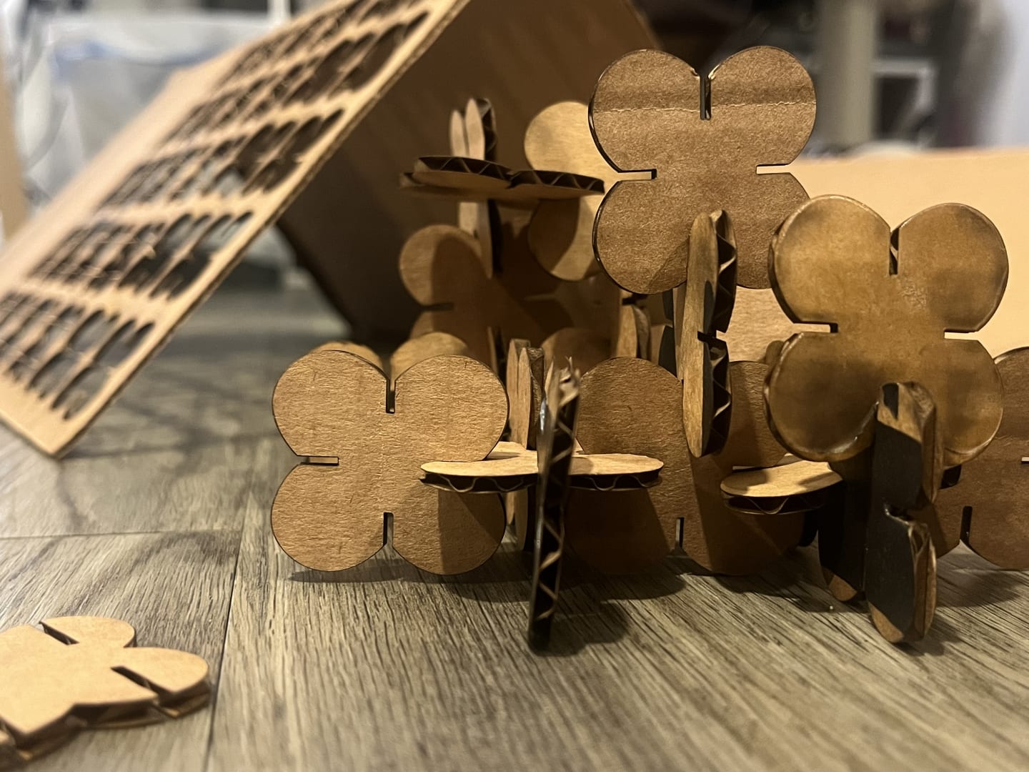 Photo of butterfly shaped laser cut items resembling a mountain when slotted together.