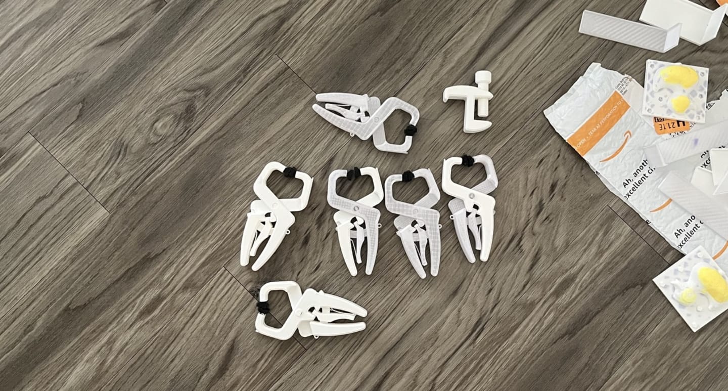 Photo of 7 clamp tools that were 3d printed.