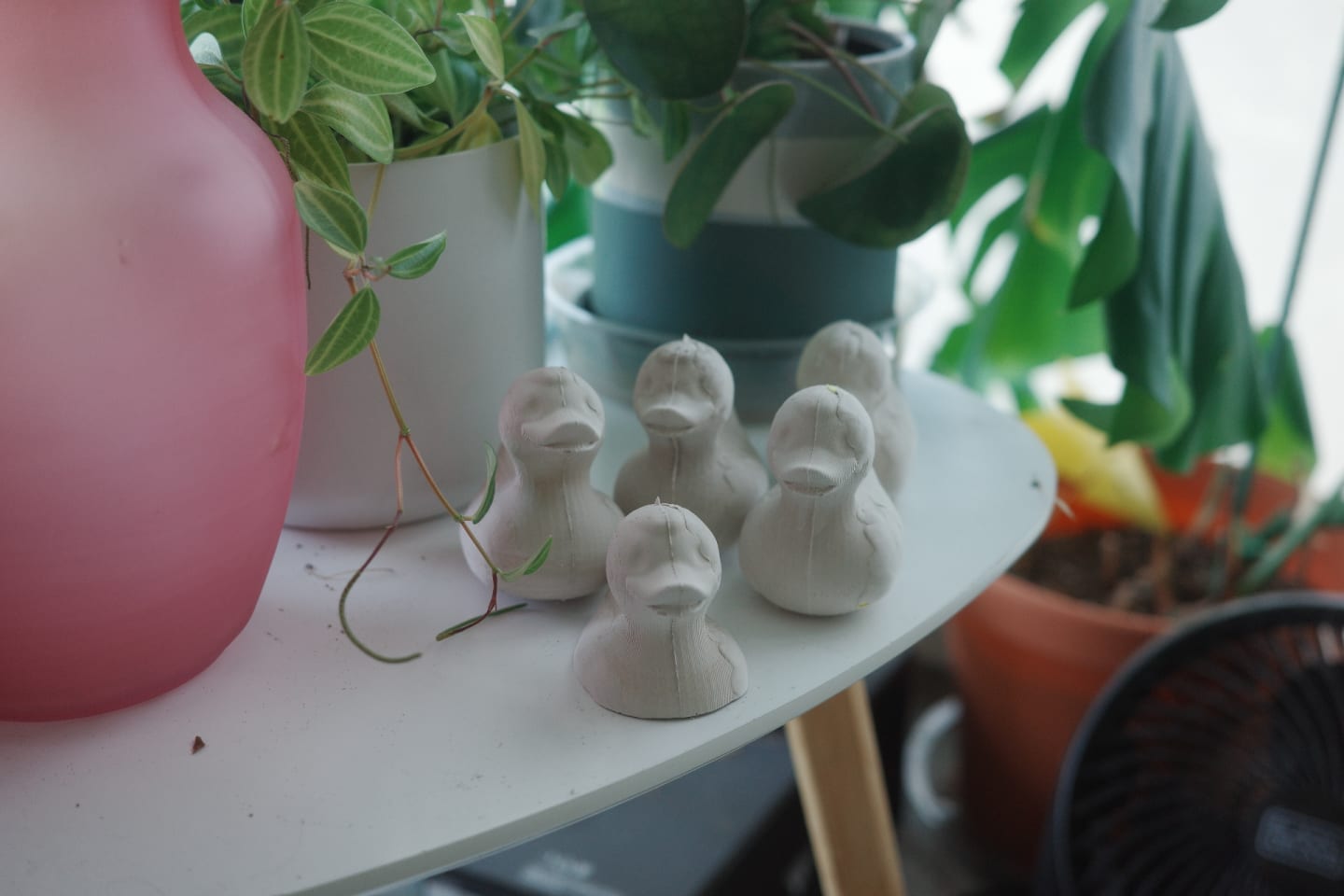 Photo of finished plasterised rubber ducks on a table.