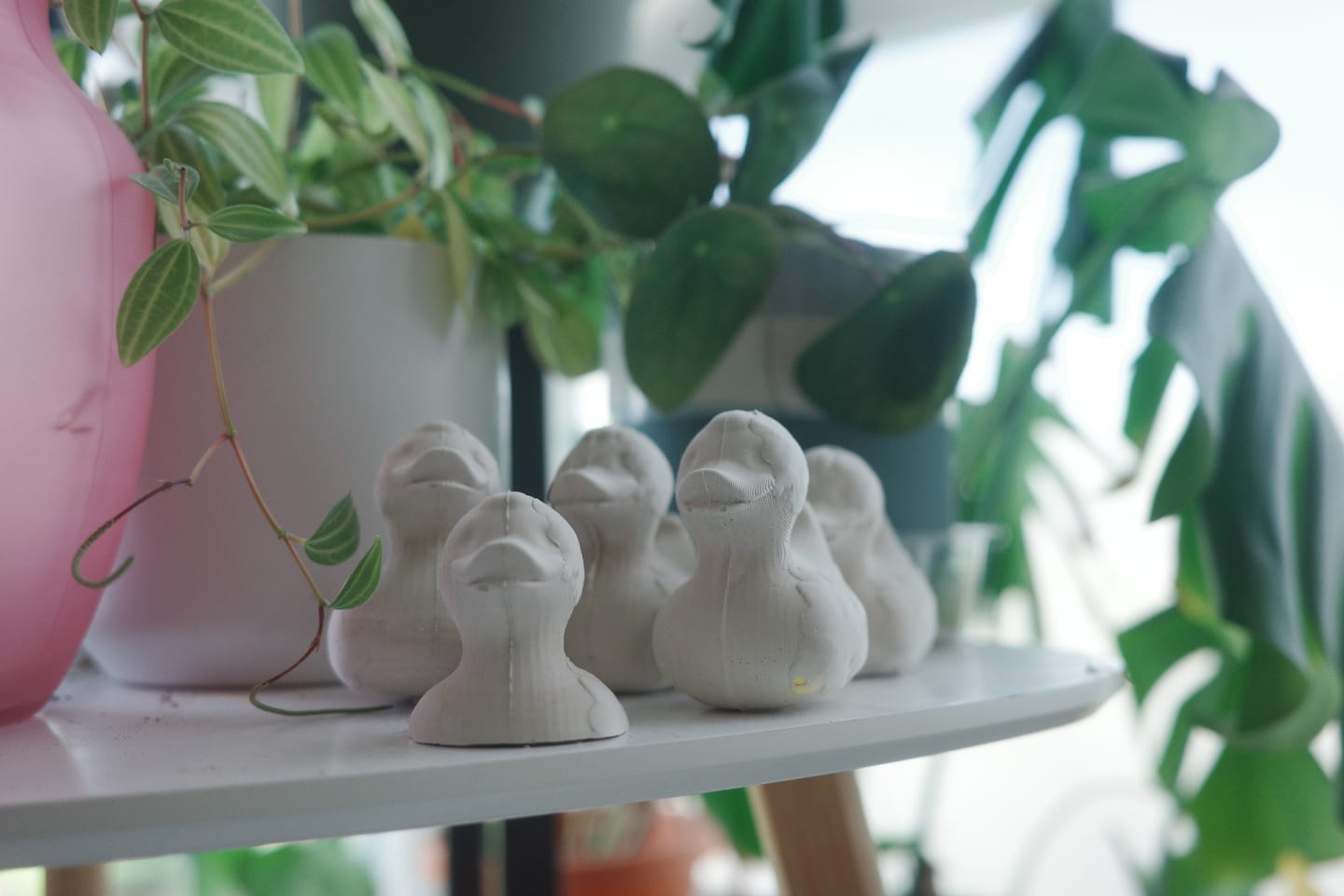 Photo of final plaster ducks in a row on top of a table.