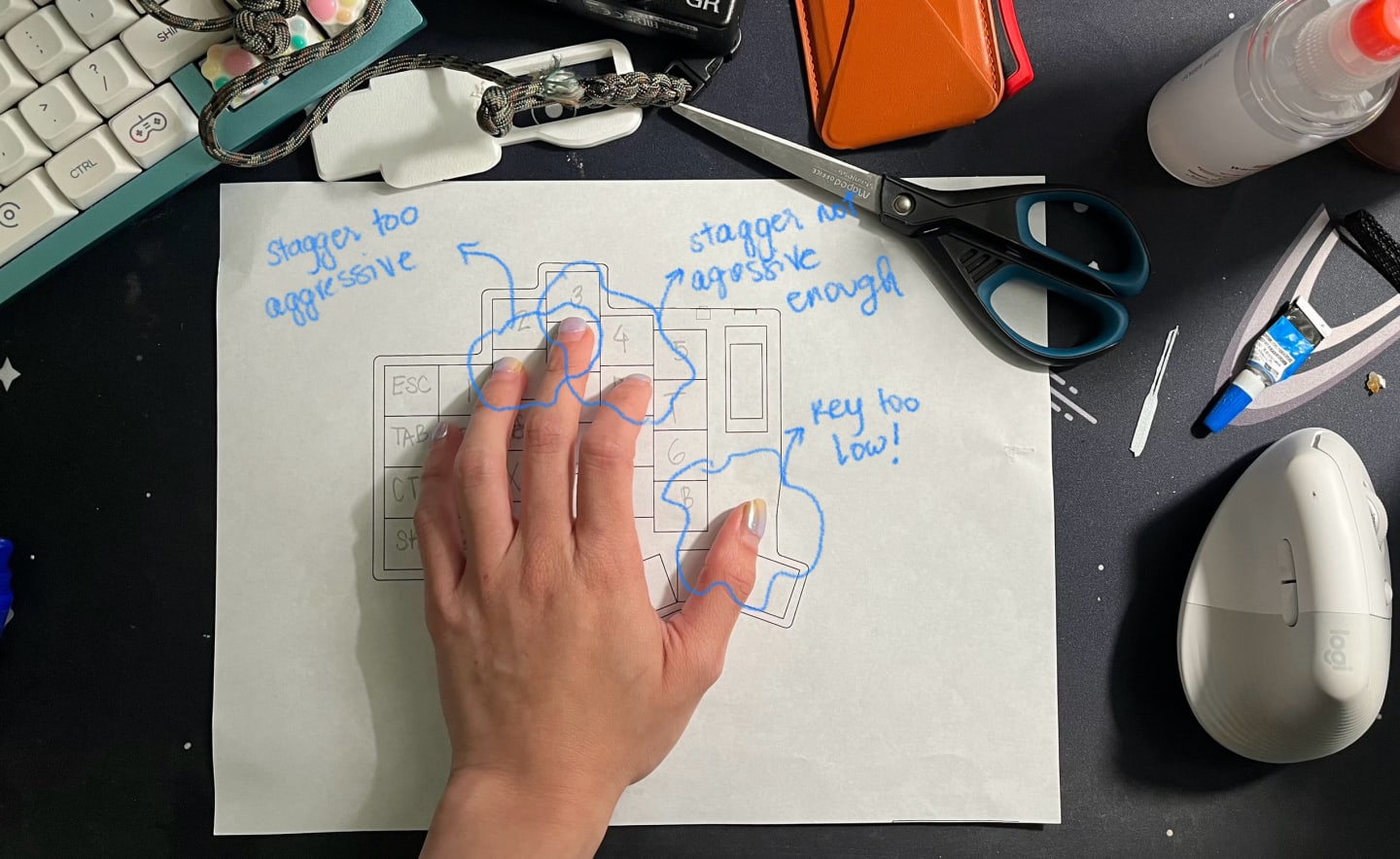 Photo of celina's hand with a printed ergogen config sample, and testing how comfortable the designed distance was ebtween keys.