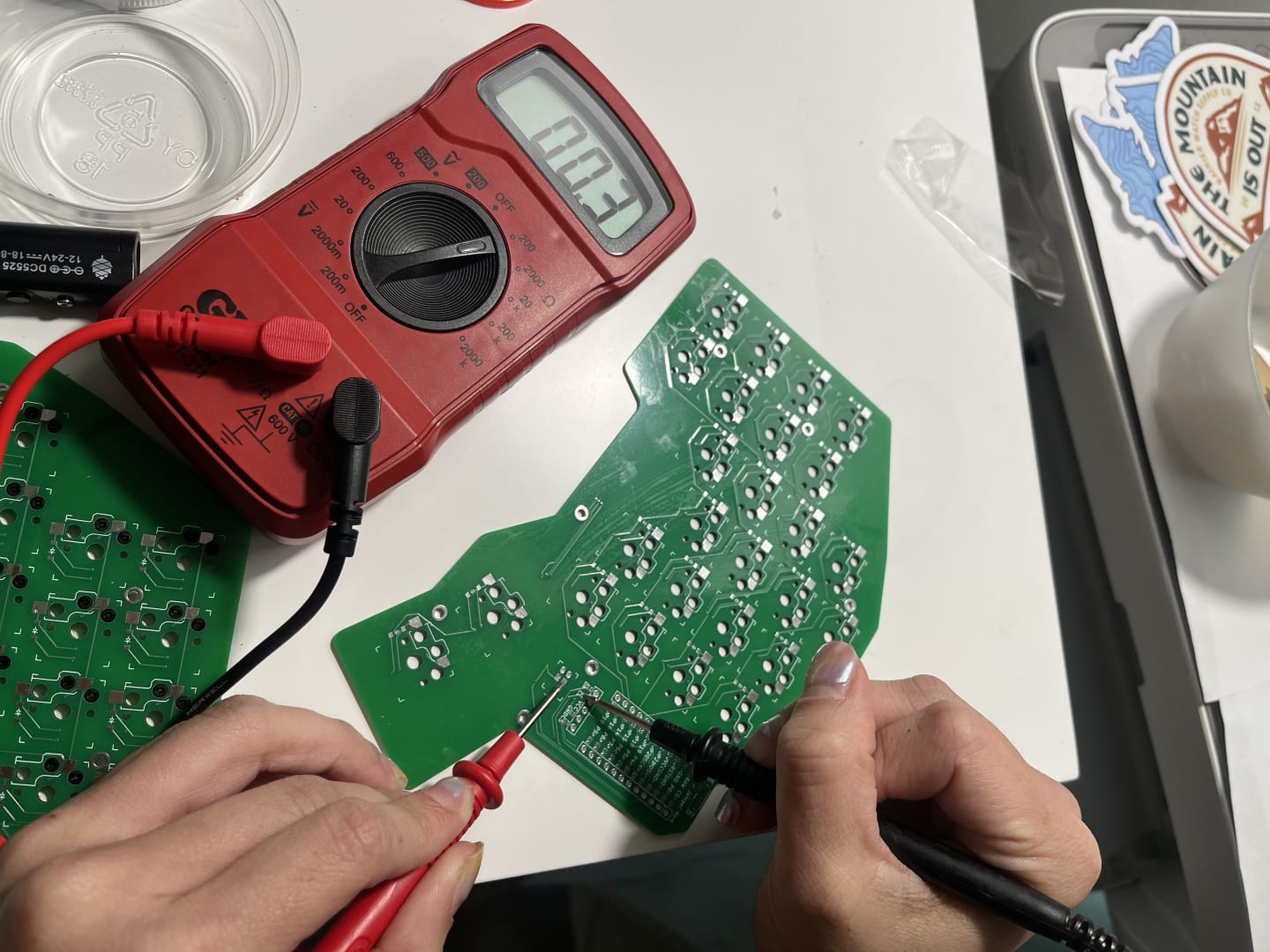 Photo of celina testing the pcb with multimeter