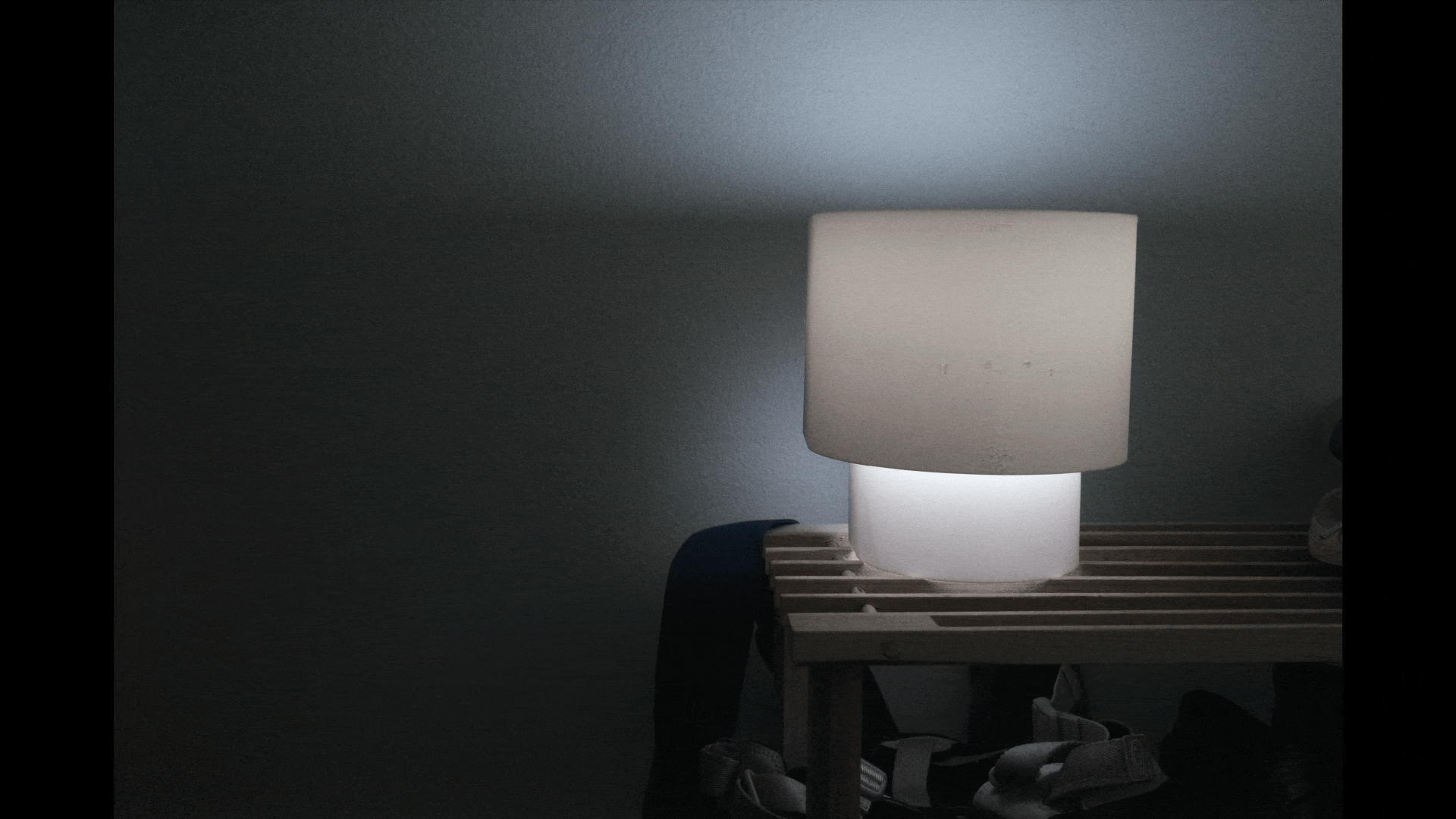 Animation of different photos of lamp shade placement trials. The first trial has the lampshade at the top, the second has a doubled up lampshade.