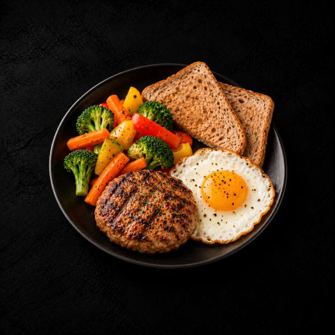 Patty Steak Sunny Side Up With Brown Bread And Veggies — Non-Veg dinner from Edibles, Kochi