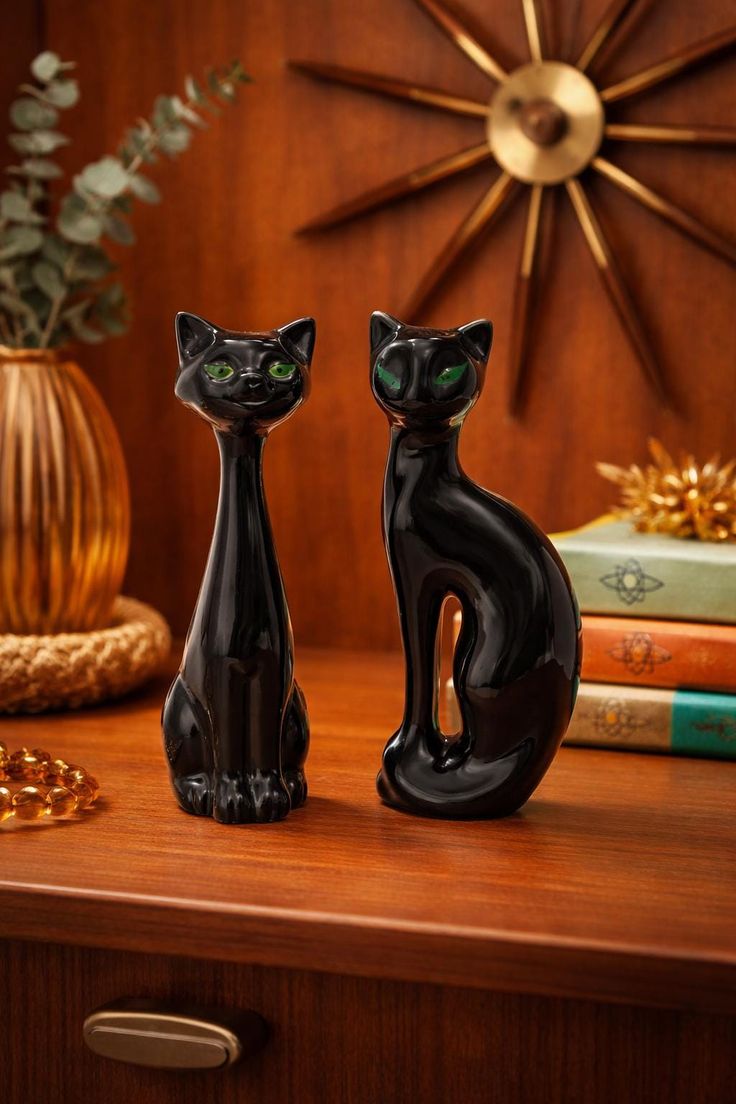 MCM black cat figurines on teak dresser