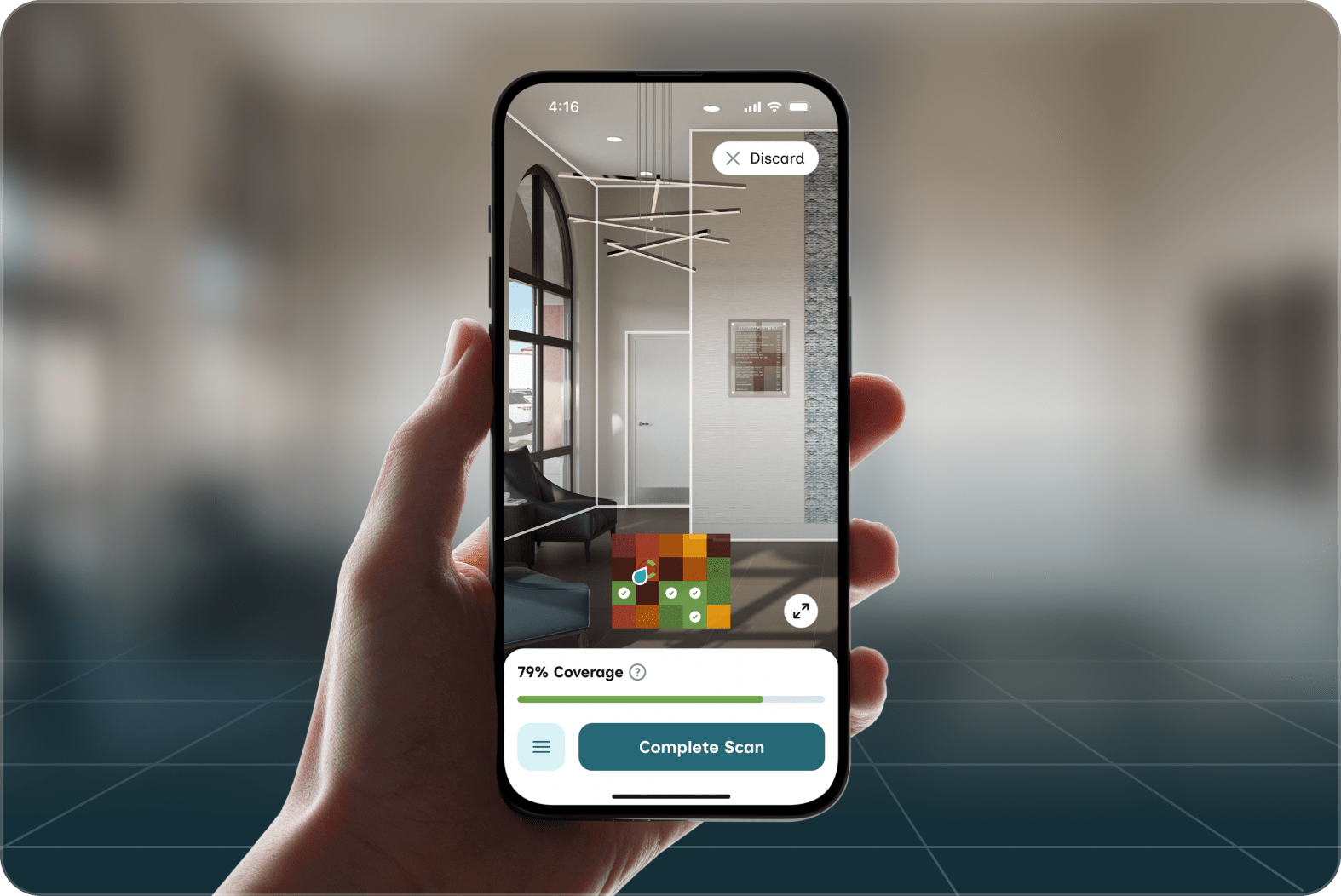 A person holding a smartphone scanning a modern indoor lobby. The phone screen displays a digital scan interface with a progress bar and colored tiles, indicating the scanning process and coverage percentage.