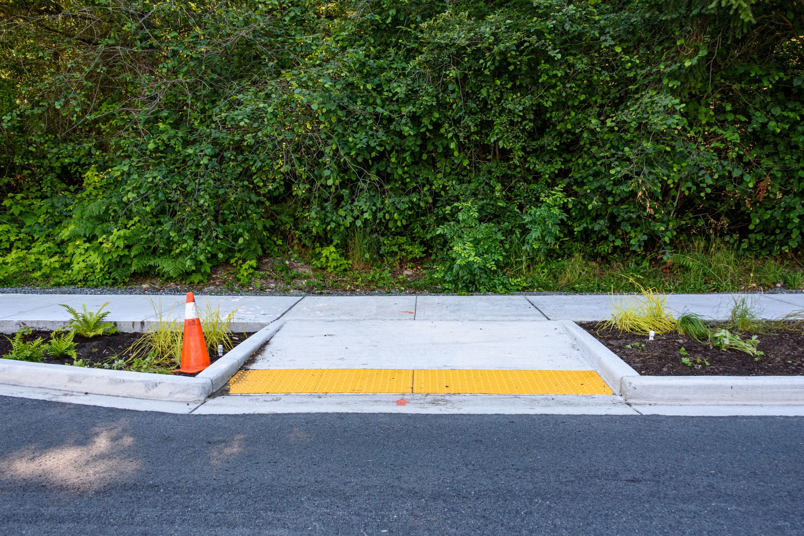 Curb cut from a road leading to a sidewalk