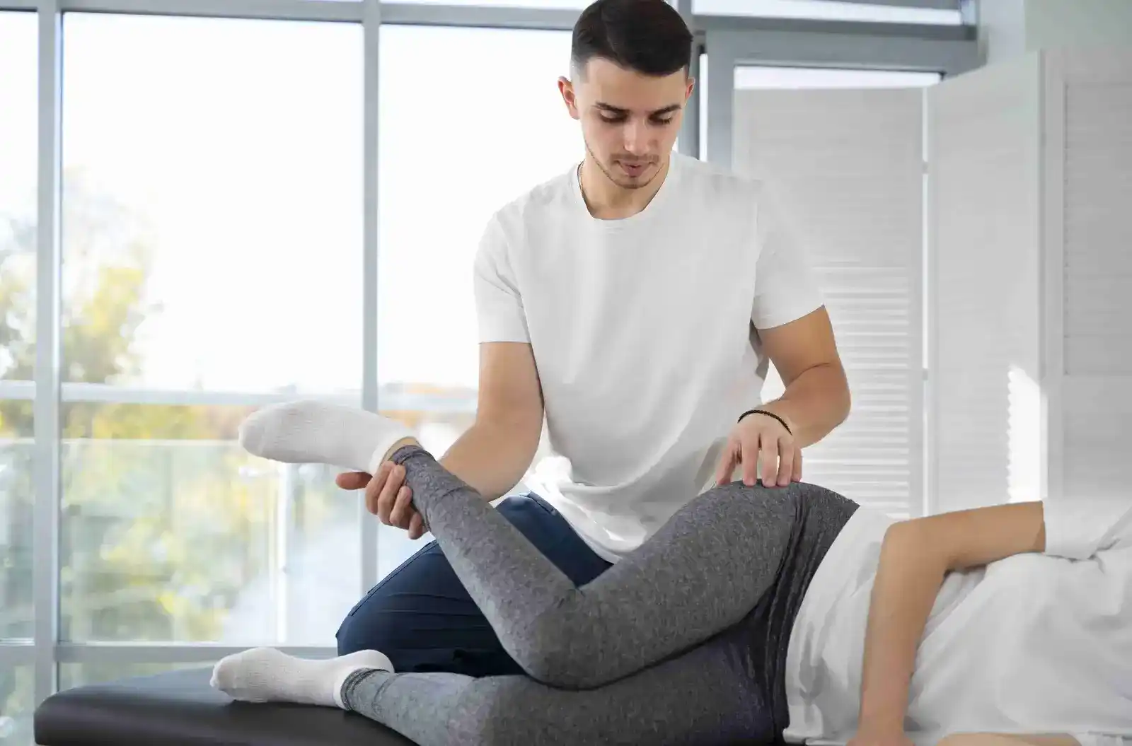 Professional physiotherapist working with patient