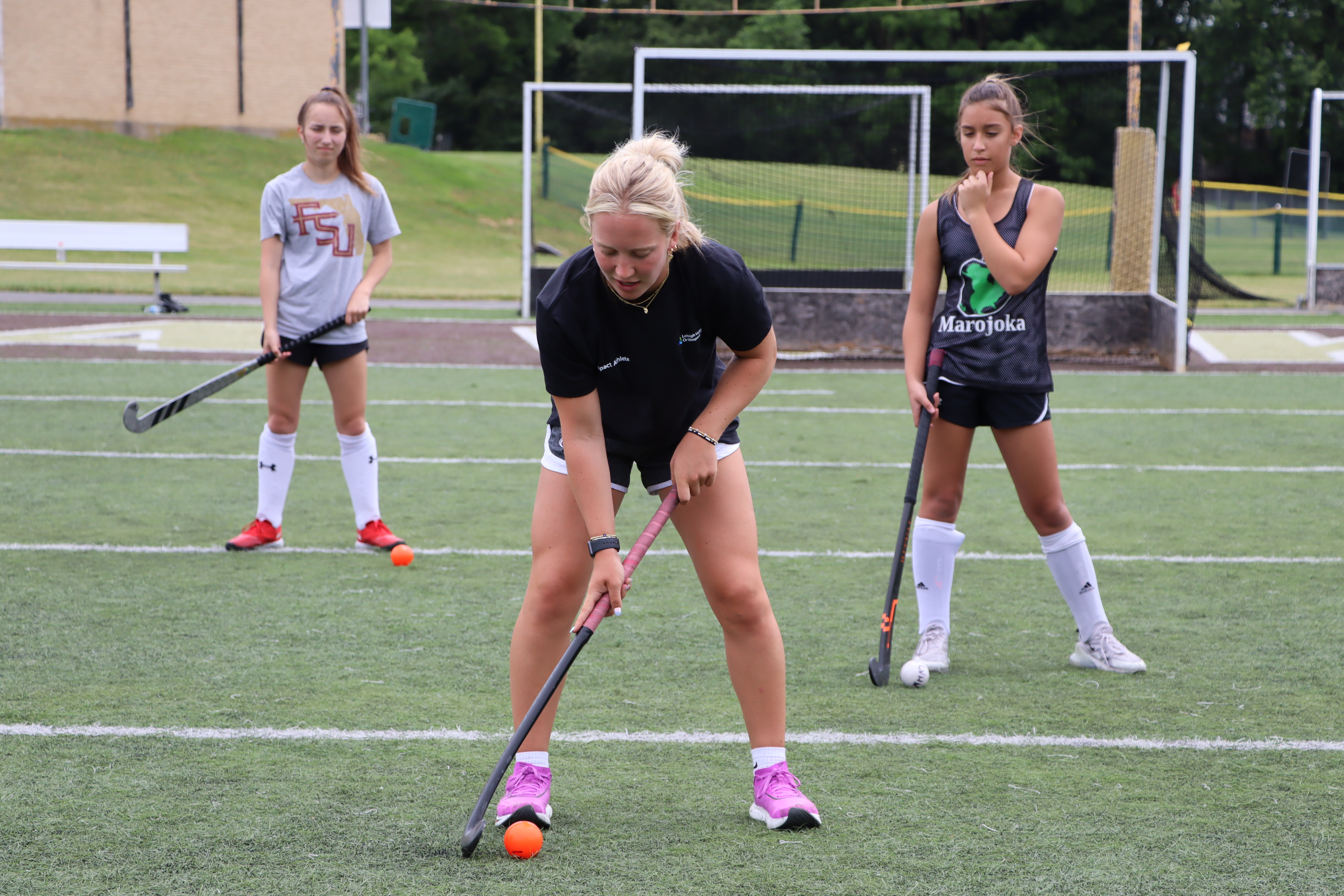 Phia coaching young athletes at clinic