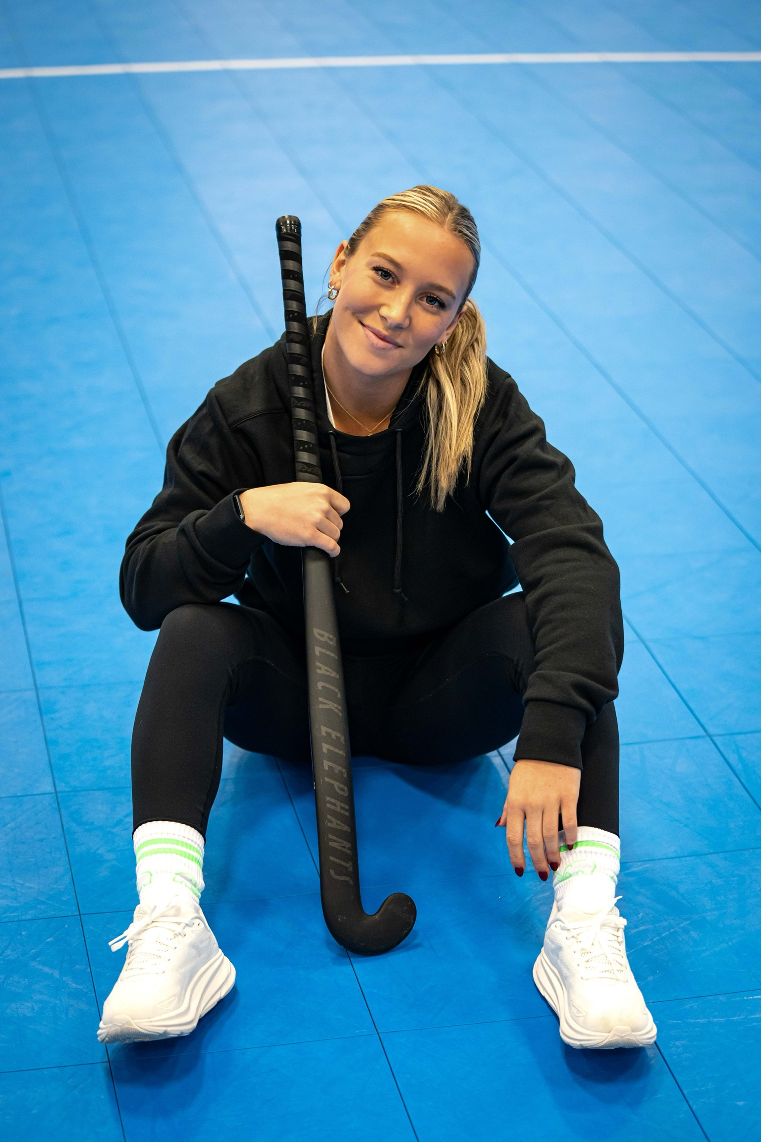 Phia Gladieux seated with stick