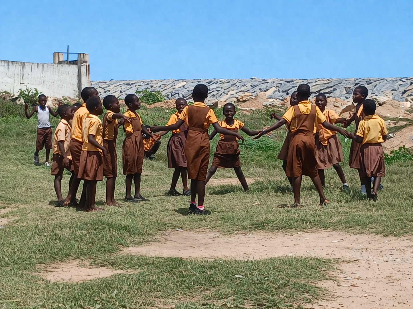 Children playing in a grassy field