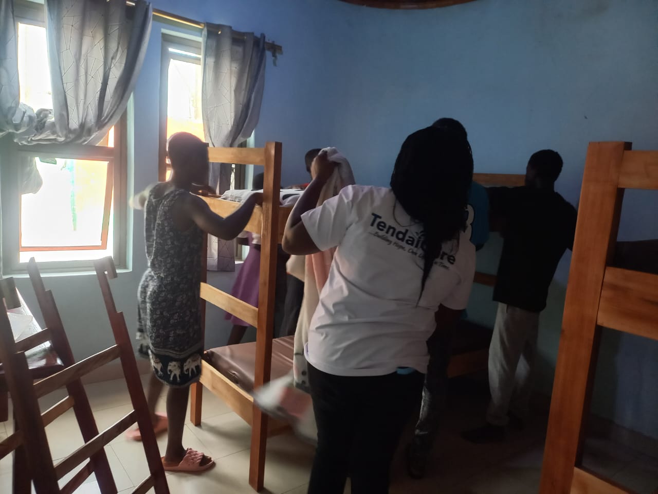 Team members unloading mattresses and bedding