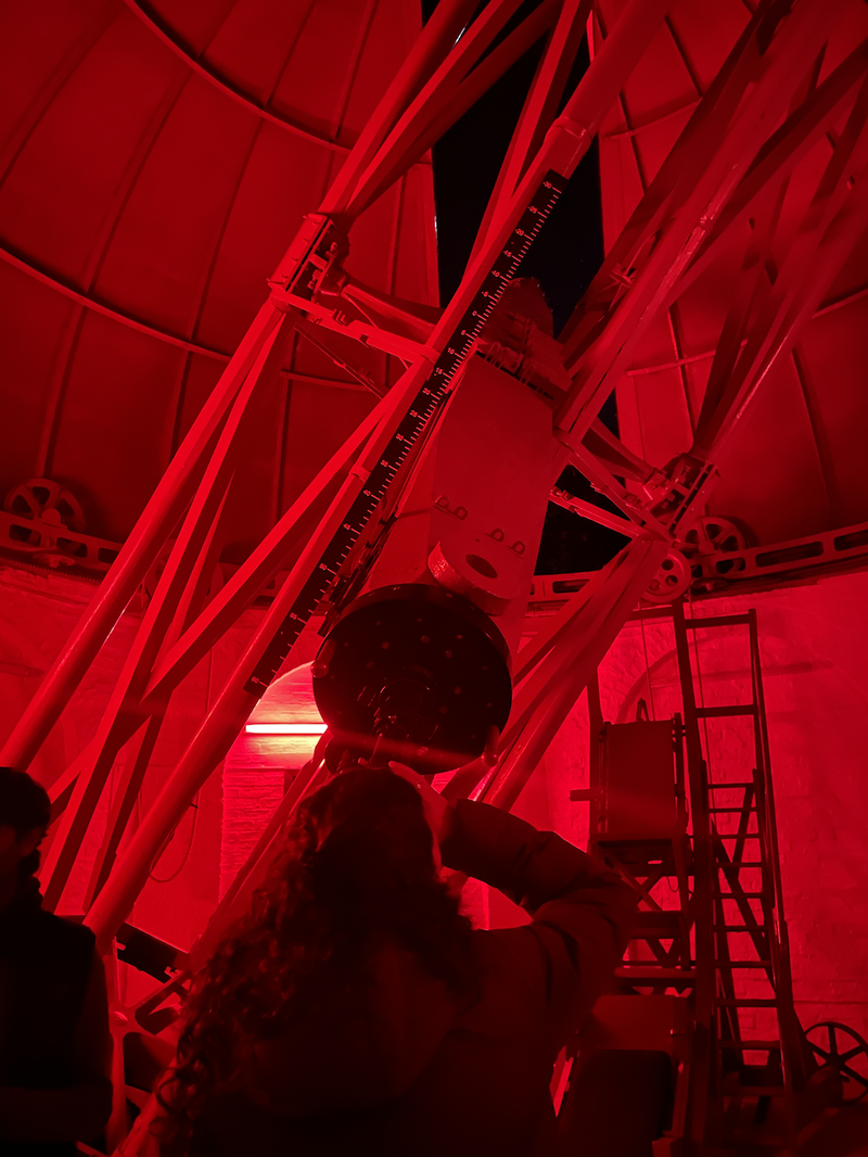 April looking through the 19th century telescope at the Institute of Astronomy.
