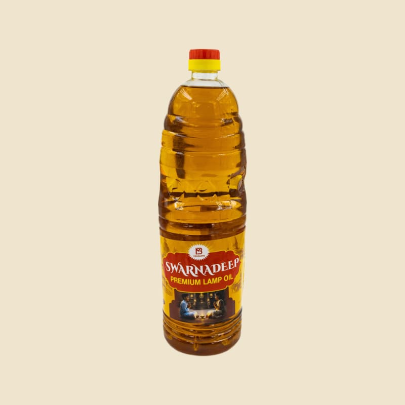 Swarnadeep Premium Lamp Oil 900 ml bottle on a warm ivory background