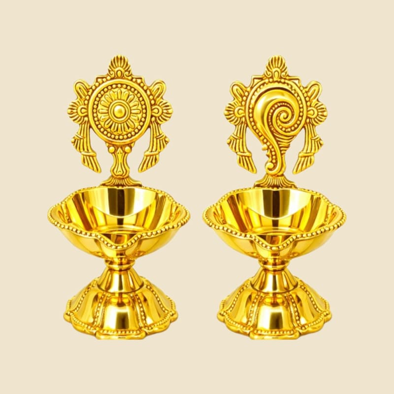 Shankh-Chakra Brass Diya Pair on a warm ivory background
