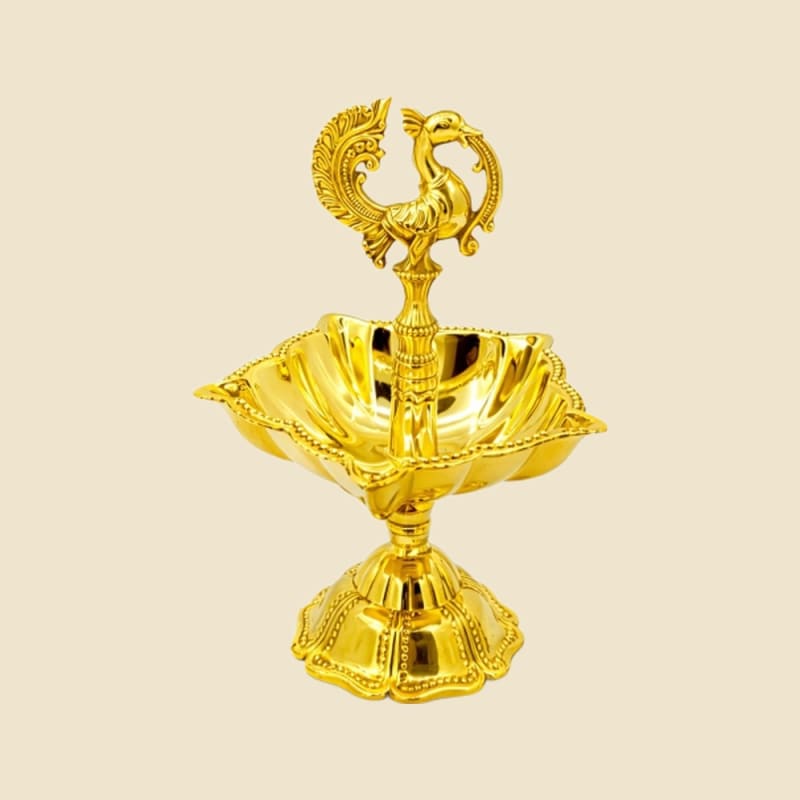 Peacock Brass Diya on a warm ivory background