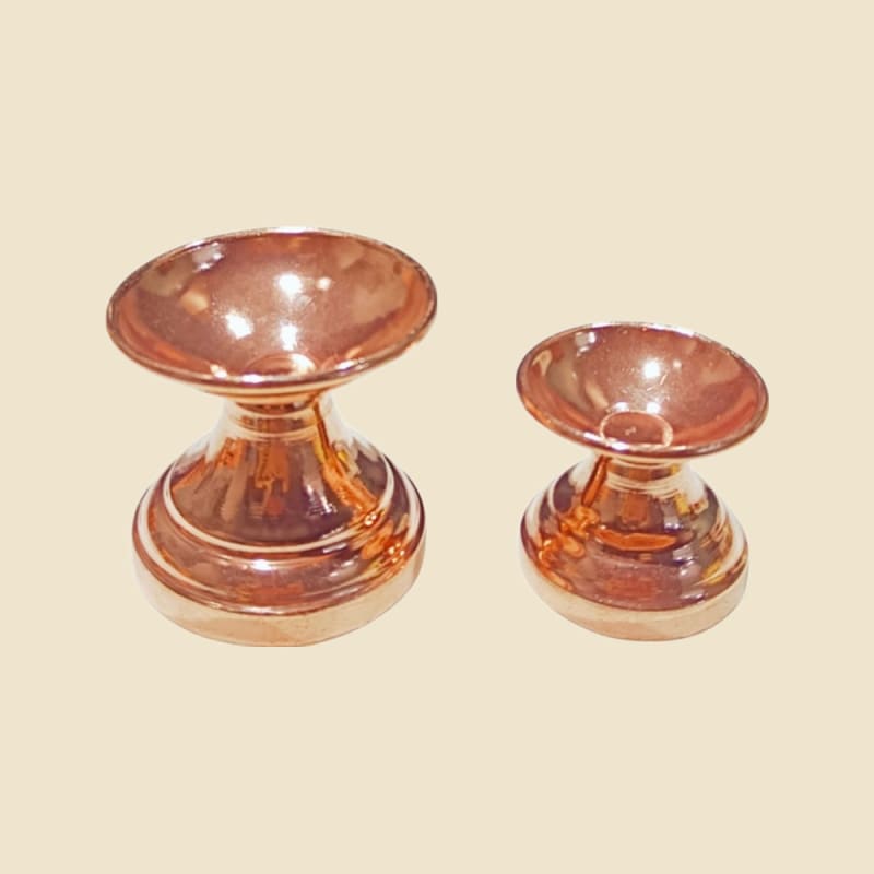 Copper Niranjan and Star Diya on a warm ivory background