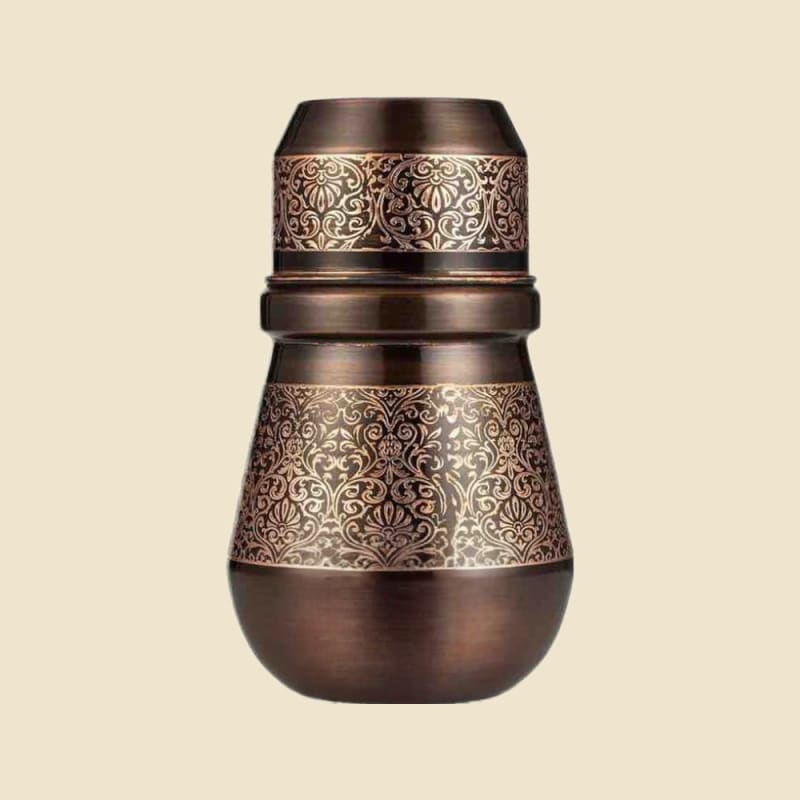 Antique and Etched Copper Water Pot on a warm ivory background