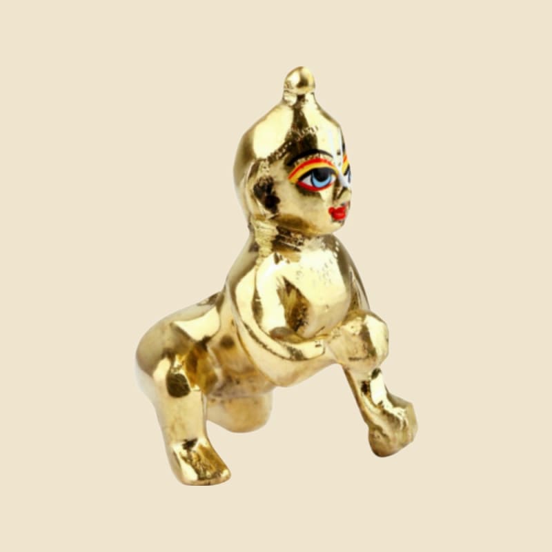 Polished Brass Laddu Gopal with Painted Eyes (Design 2) on a warm ivory background