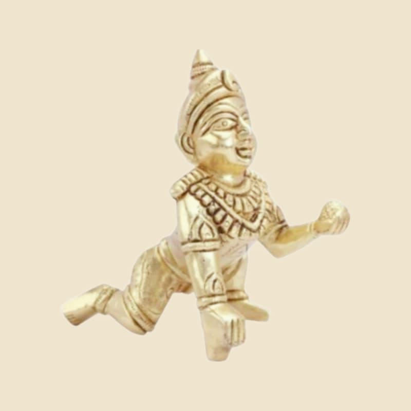 Brass Laddu Gopal with Crown, Antique Finish on a warm ivory background