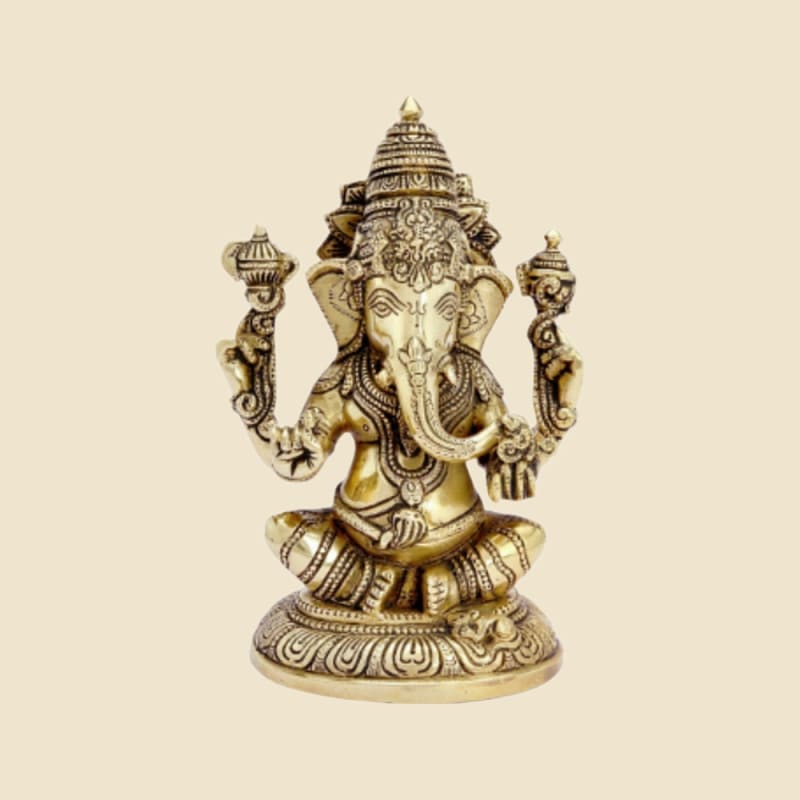 Brass Ganesha with Tall Crown on Round Base on a warm ivory background