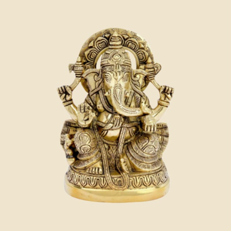 Brass Ganesha with Arch (Prabhavali) on a warm ivory background