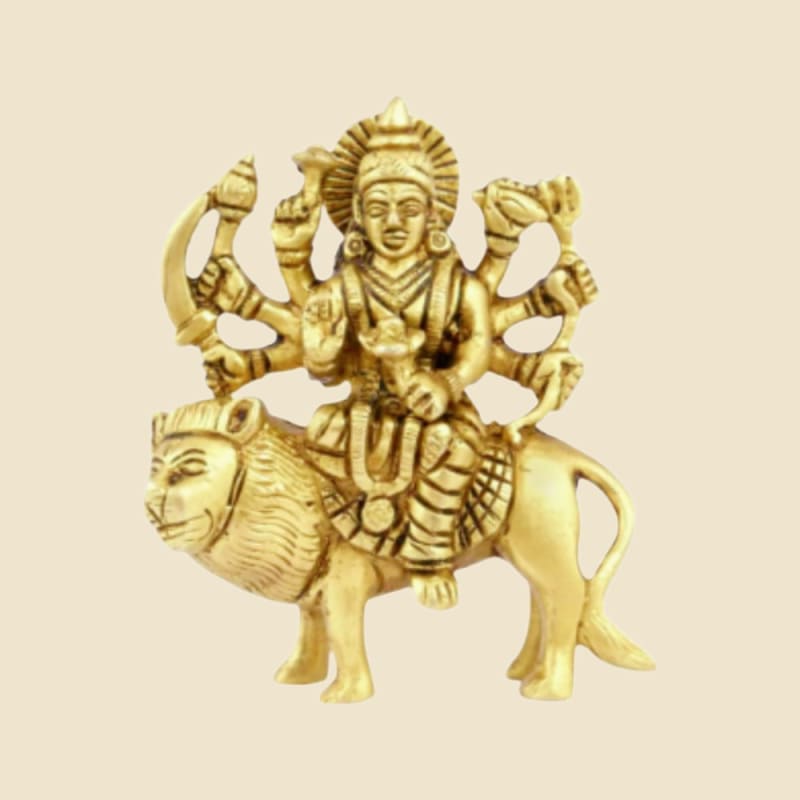 Eight-armed Brass Durga on Lion, Bright Finish on a warm ivory background