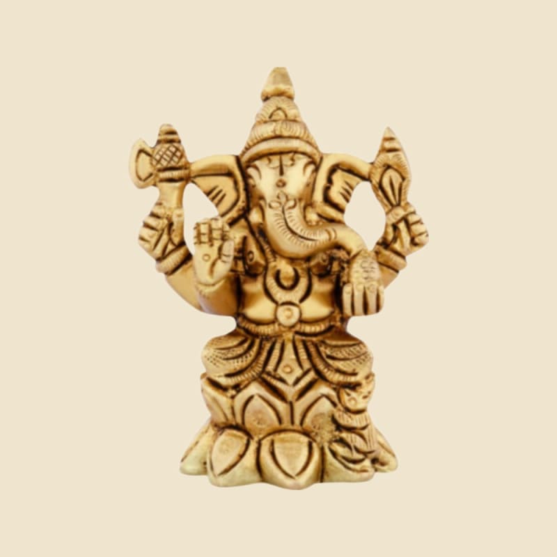 Brass Ganesha with Large Ears on Lotus Base on a warm ivory background