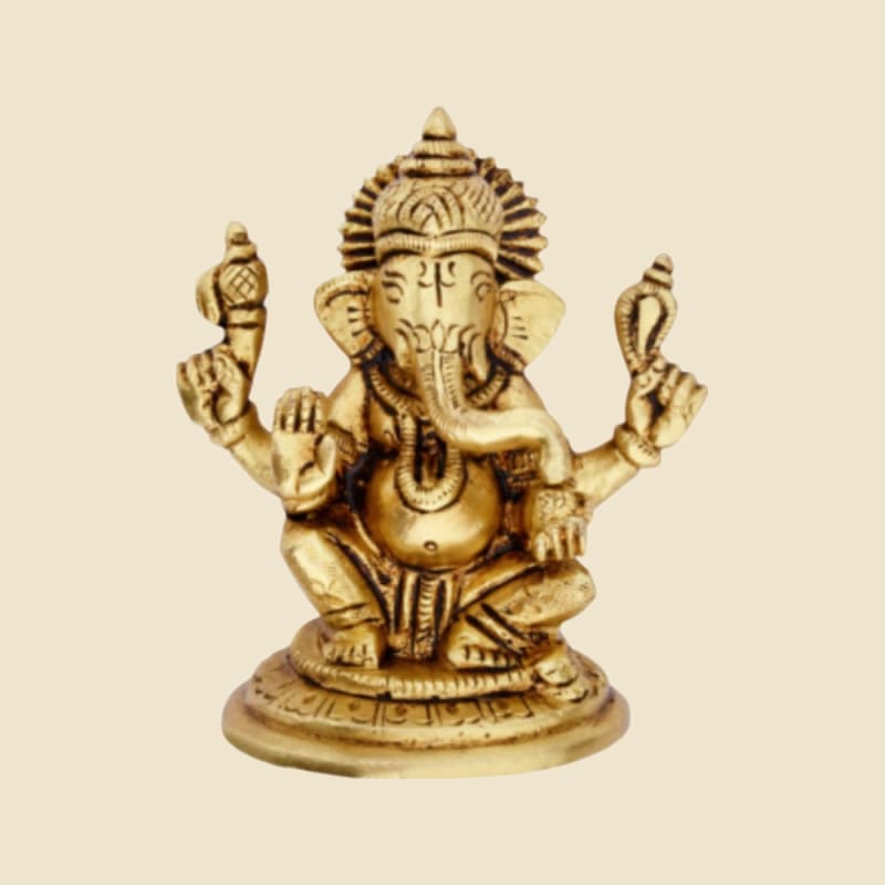 Brass Ganesha Seated on Round Base on a warm ivory background