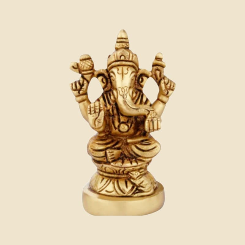 Small Brass Ganesha on Lotus on a warm ivory background