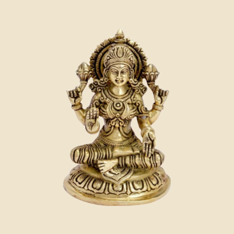 Brass Lakshmi Seated, Antique Finish on a warm ivory background