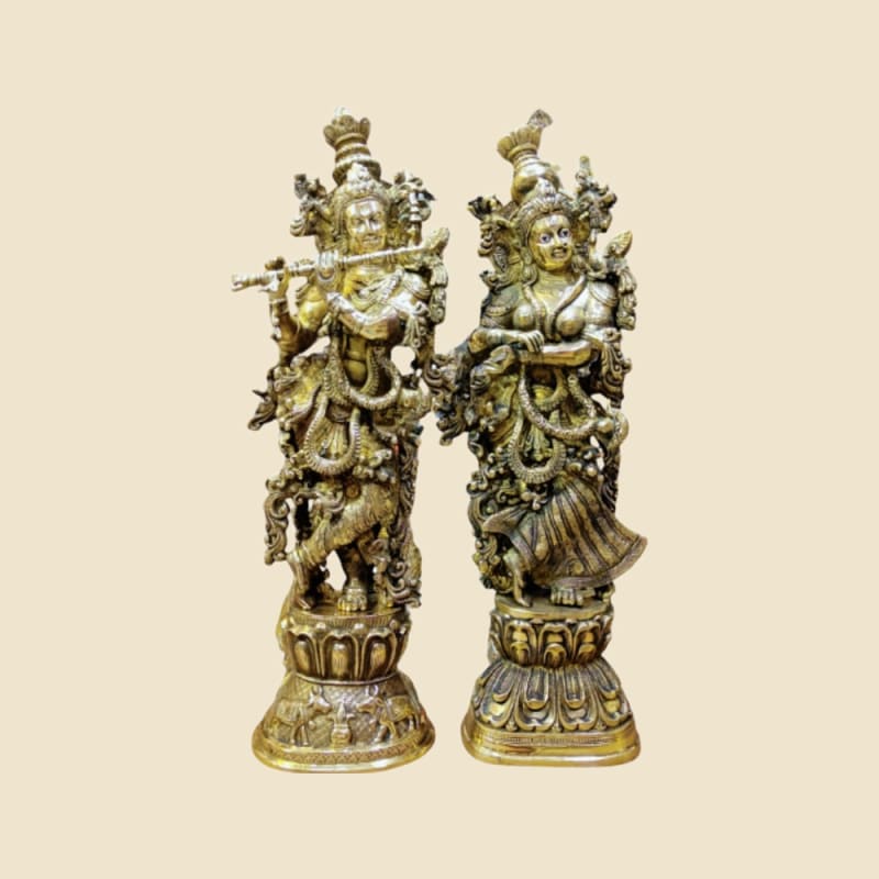 Brass Radha-Krishna Pair on Pedestals on a warm ivory background