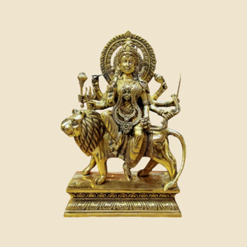 Brass Durga on Lion, Tiered Base on a warm ivory background