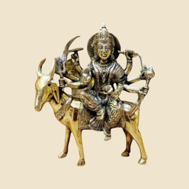 Brass Multi-armed Goddess on Bull on a warm ivory background