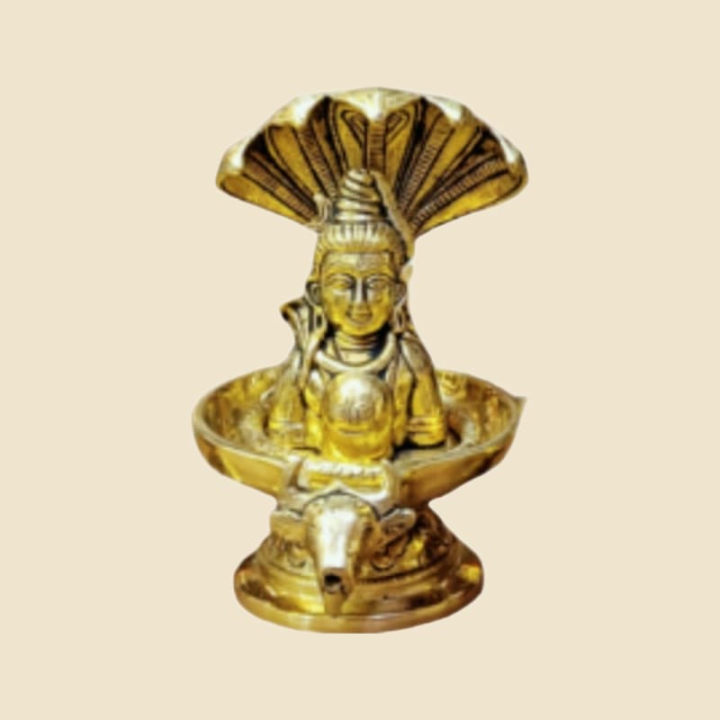 Brass Shivling with Shiva Face and Serpent on a warm ivory background