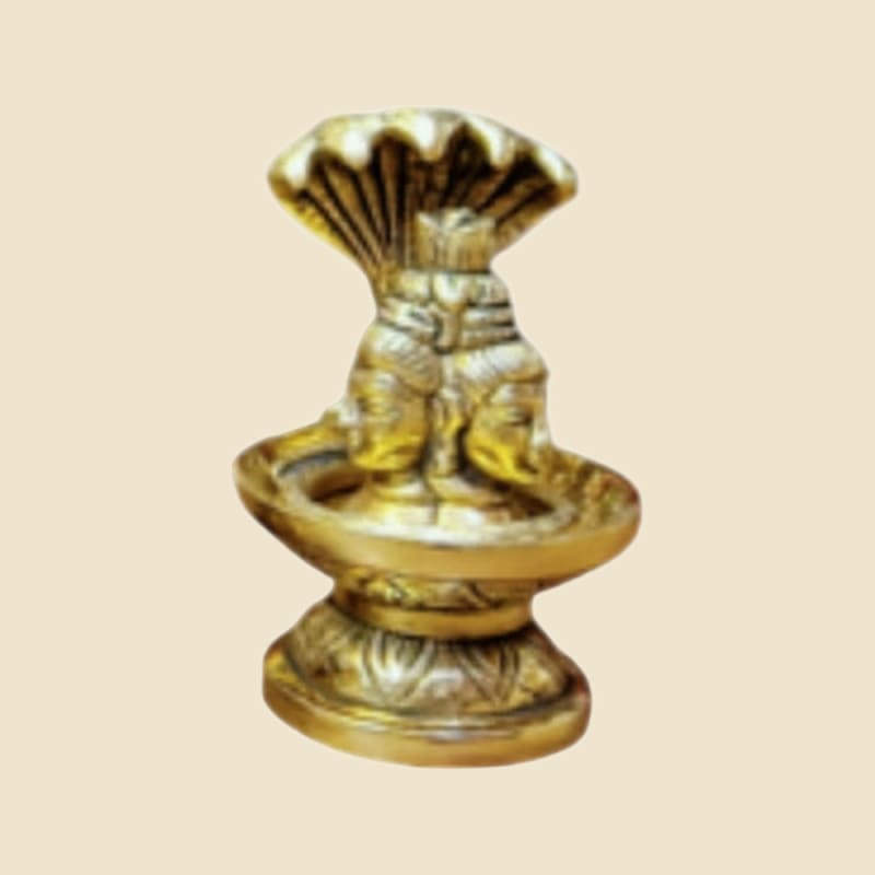 Small Brass Shivling with Serpent on a warm ivory background