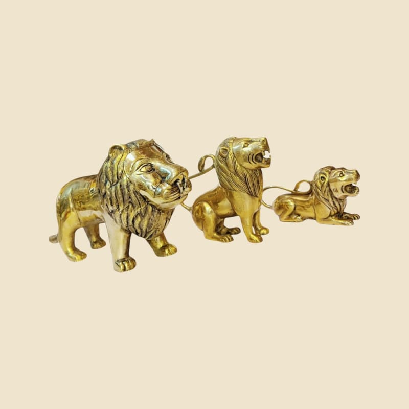 Brass Lion Trio on a warm ivory background