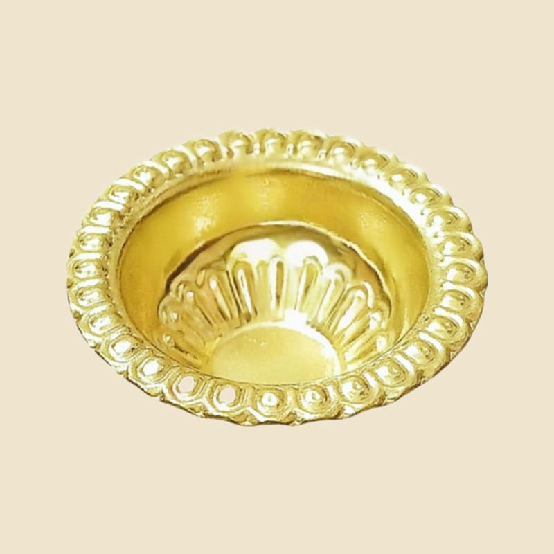 Brass Kesar Cup on a warm ivory background